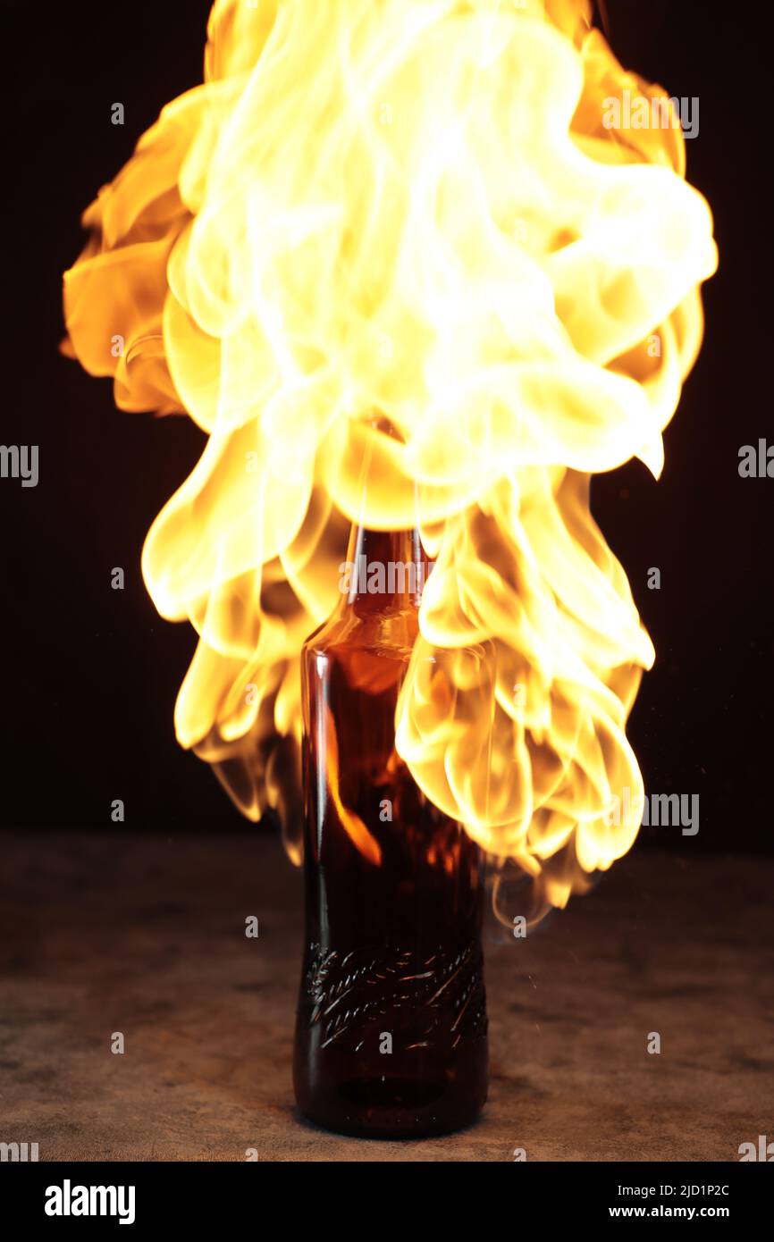 Beer bottle in fire and flame Stock Photo