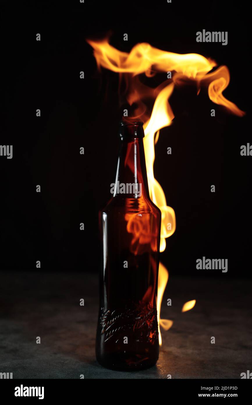 Beer bottle in fire and flame Stock Photo Alamy