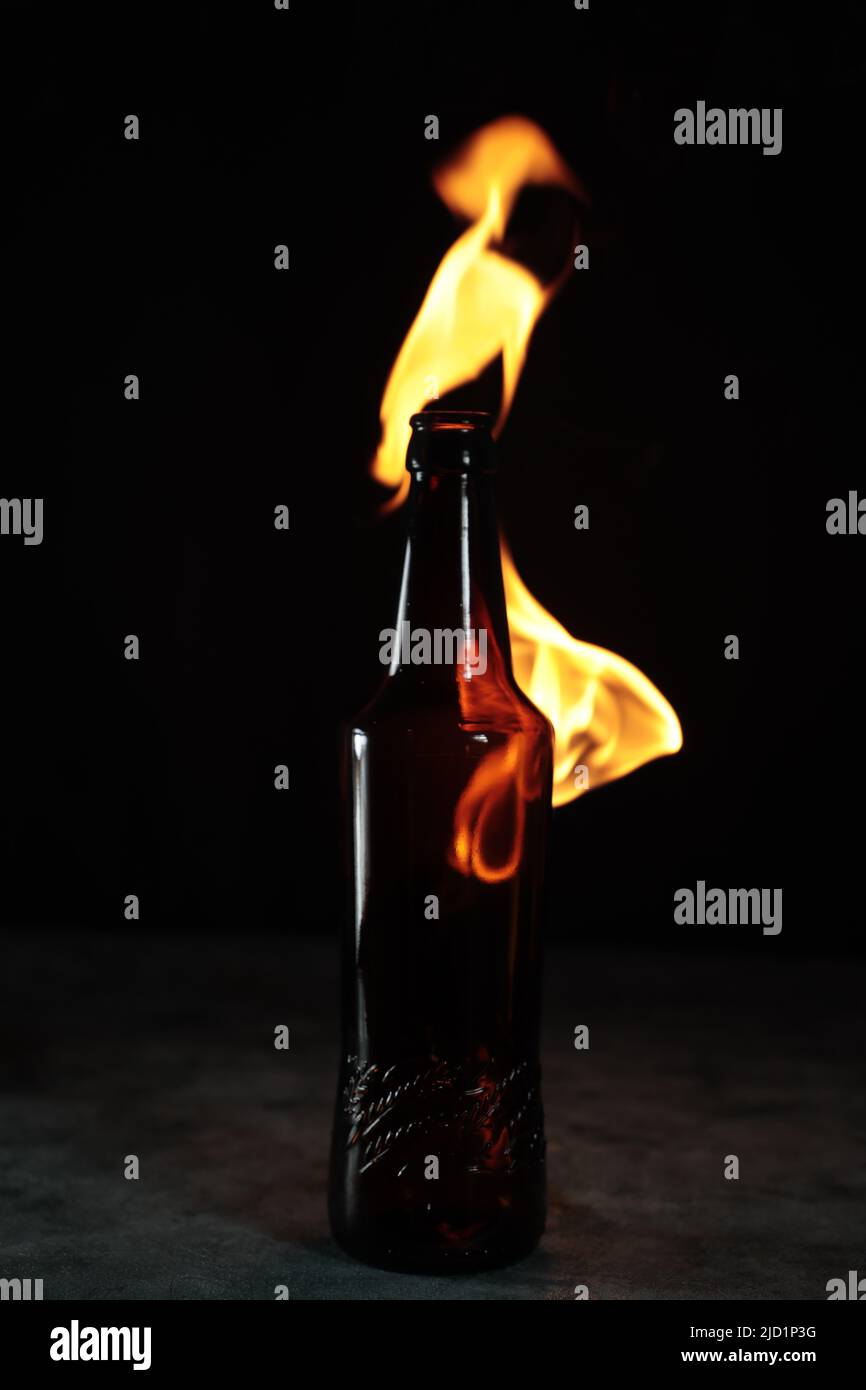 Beer bottle in fire and flame Stock Photo