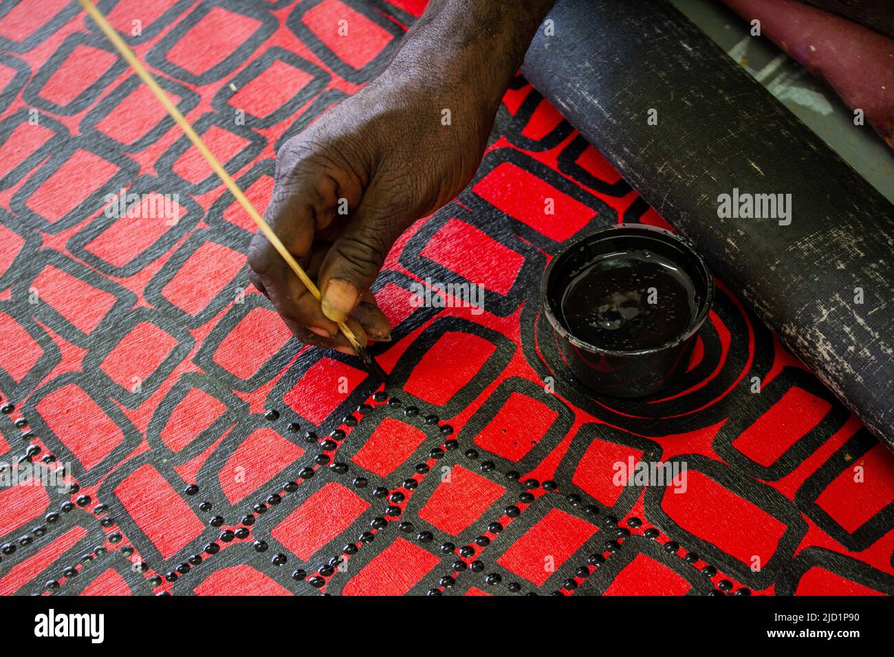 Australian Aboriginal artist painting traditional designs Stock Photo
