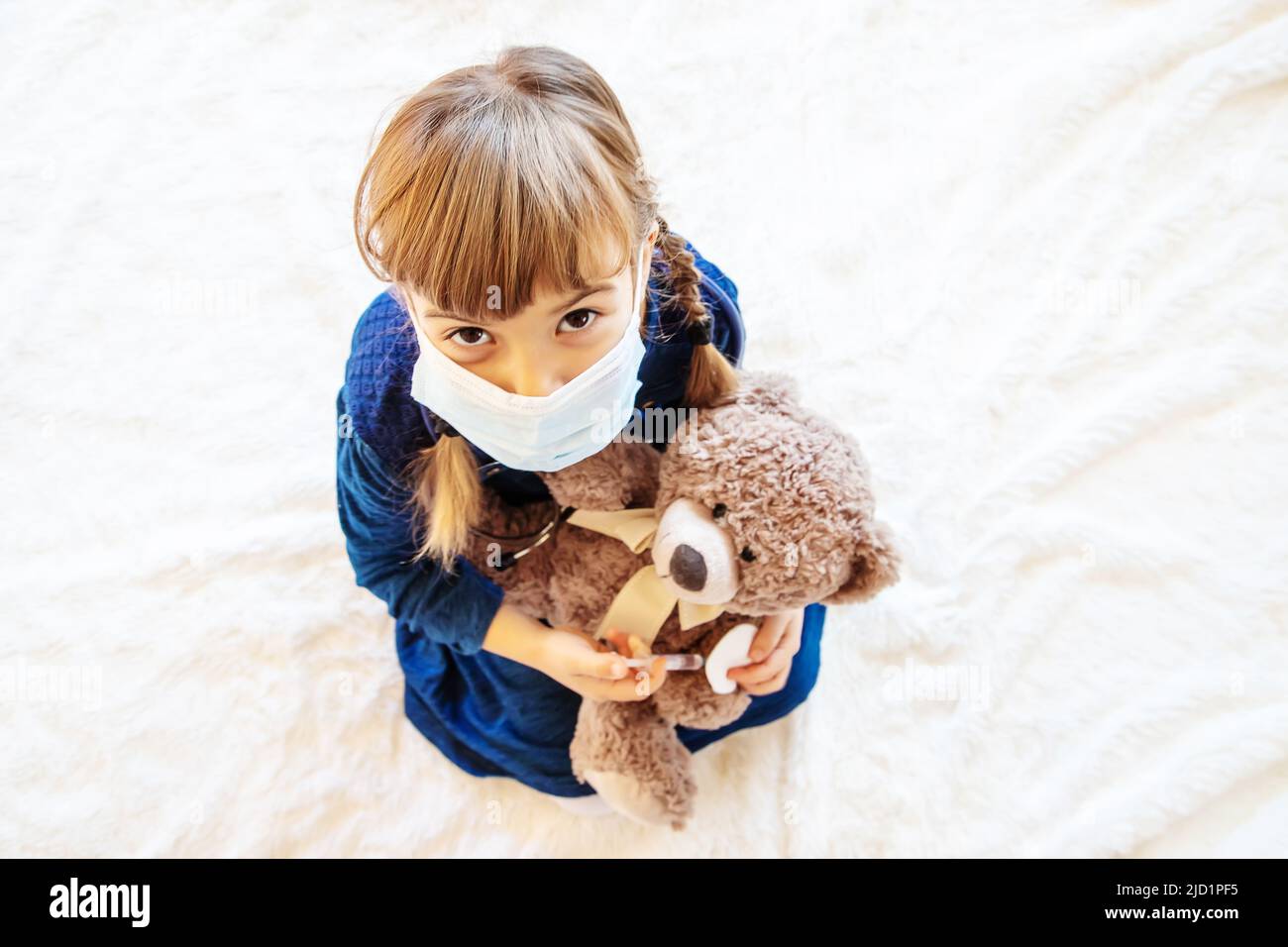 child-treats-a-bear-the-game-of-the-doctor-selective-focus-stock