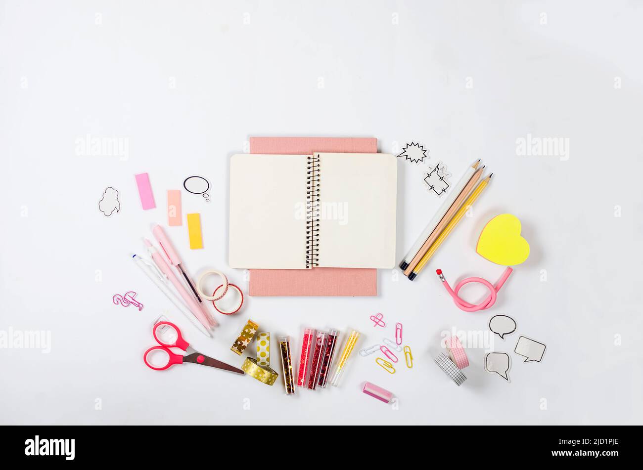 Girly pink desktop and stationery with blank notebook. Frame of ...