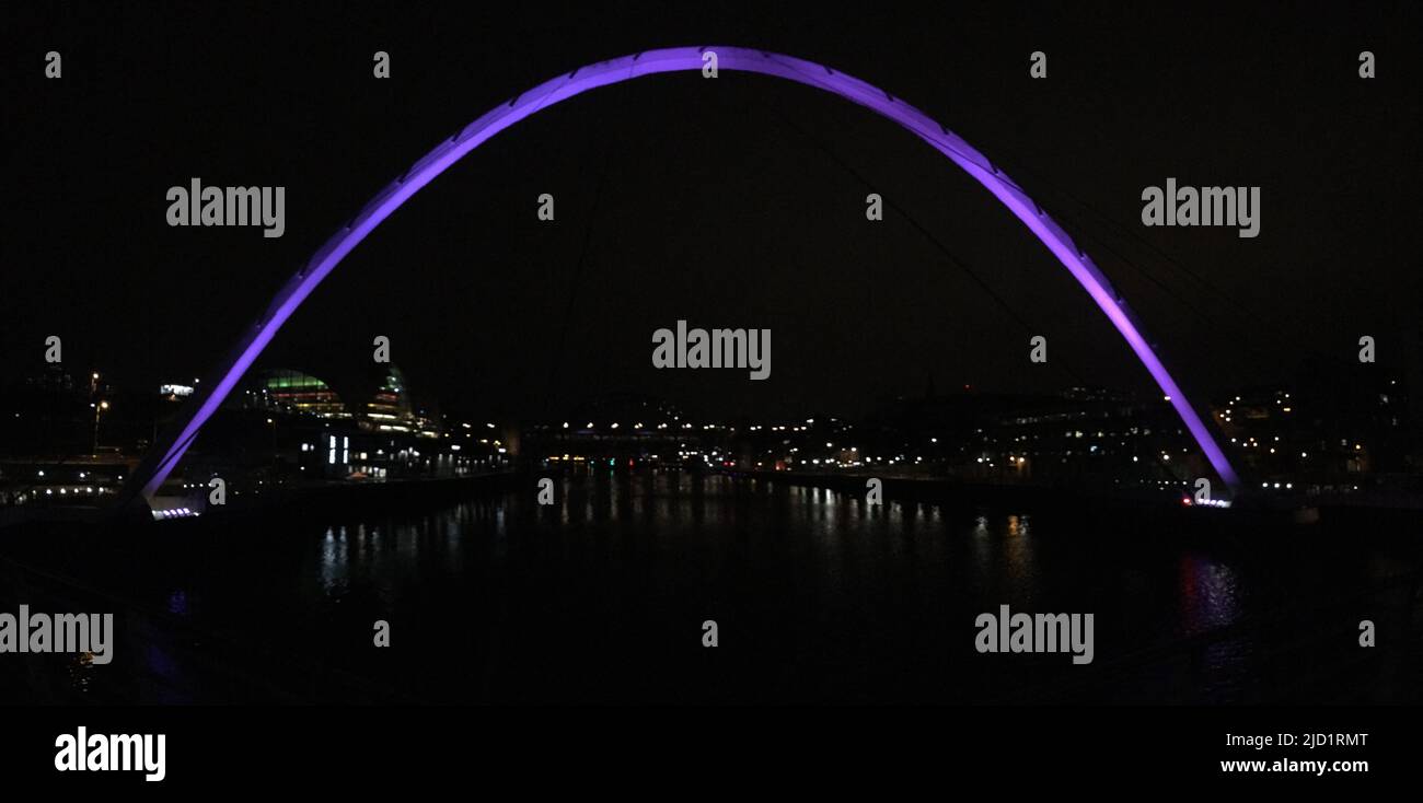 The Gateshead Millennium Bridge illuminated in purple. Newcastle Upon Tyne Stock Photo