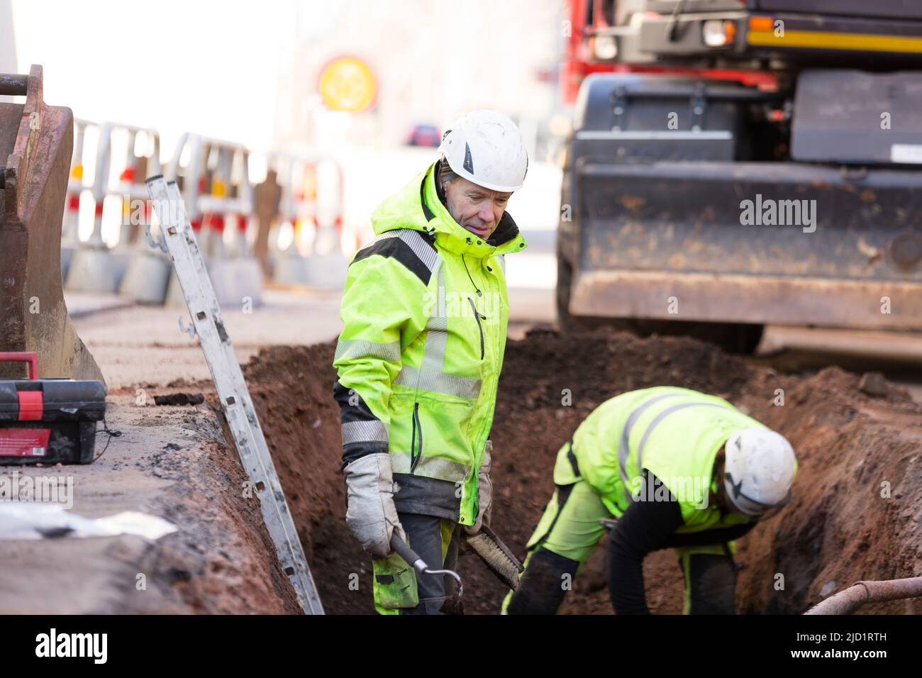 Workers in reflective clothing during work Stock Photo