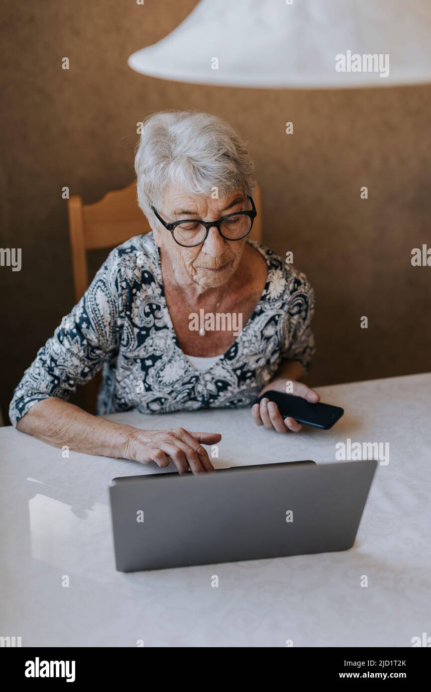 Senior woman using laptop Stock Photo