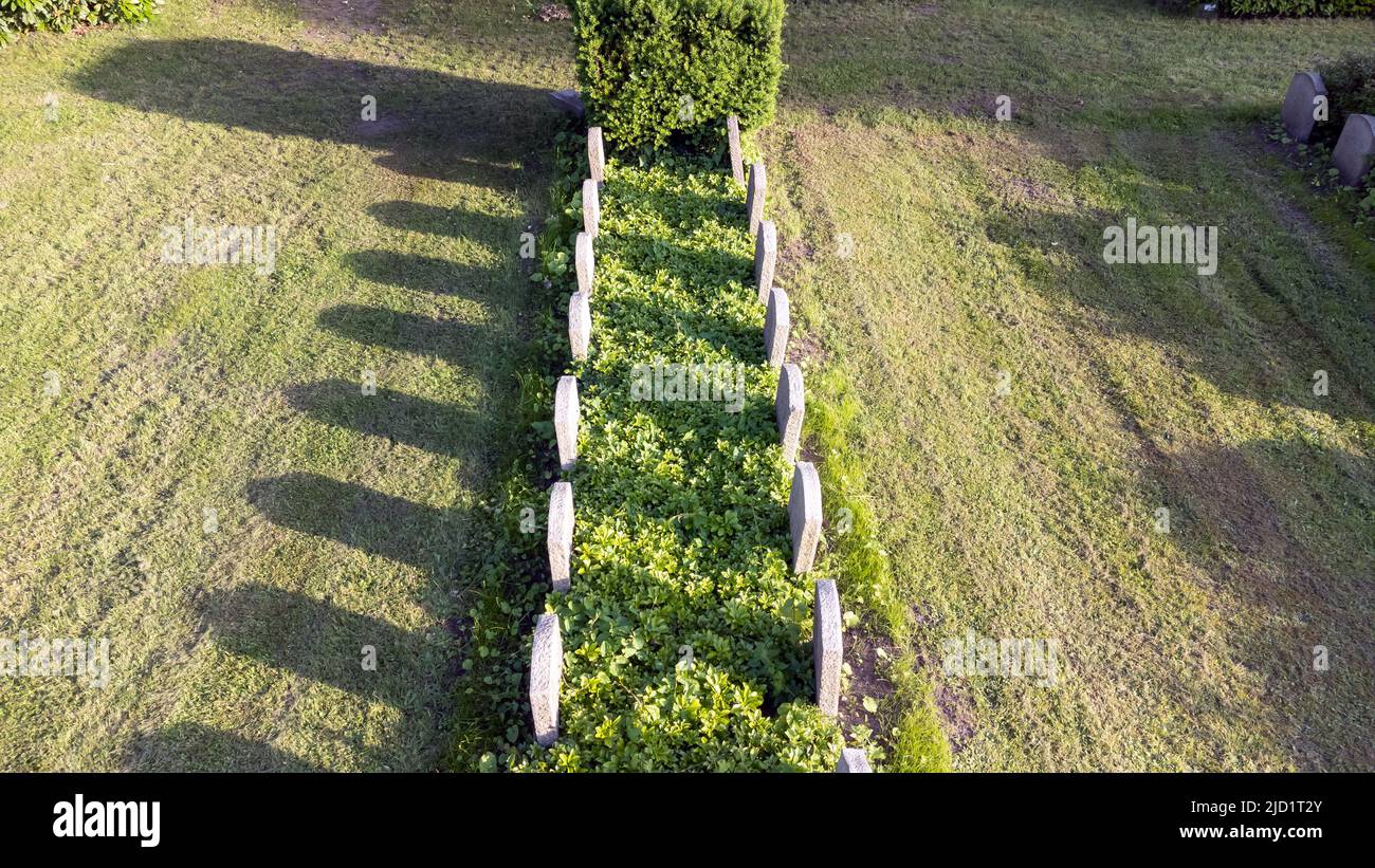 tombstones in a row at a german cemetery Stock Photo