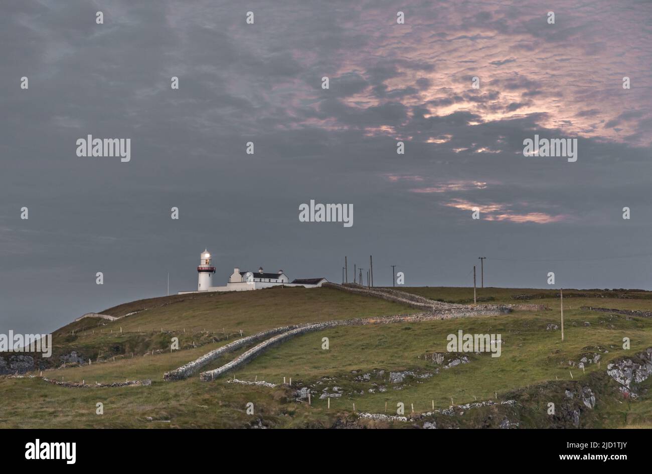 Galley Head, Cork, Ireland. 15th June, 2022. Clouds illuminated by a full Strawberry Moon over the Galley Head Lighthouse in West Cork, Ireland. - Pic Stock Photo