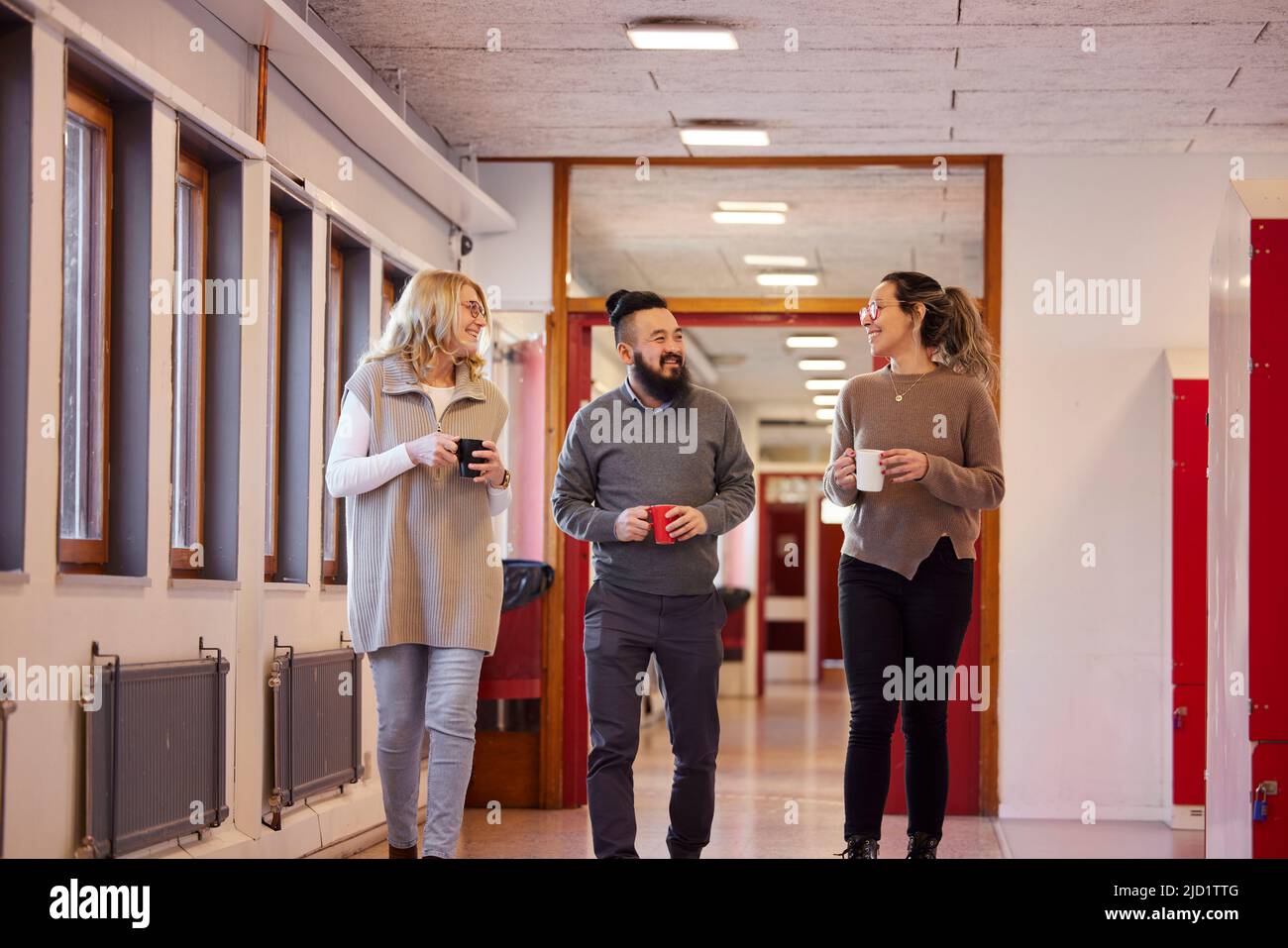 Co-workers talking at corridor Stock Photo