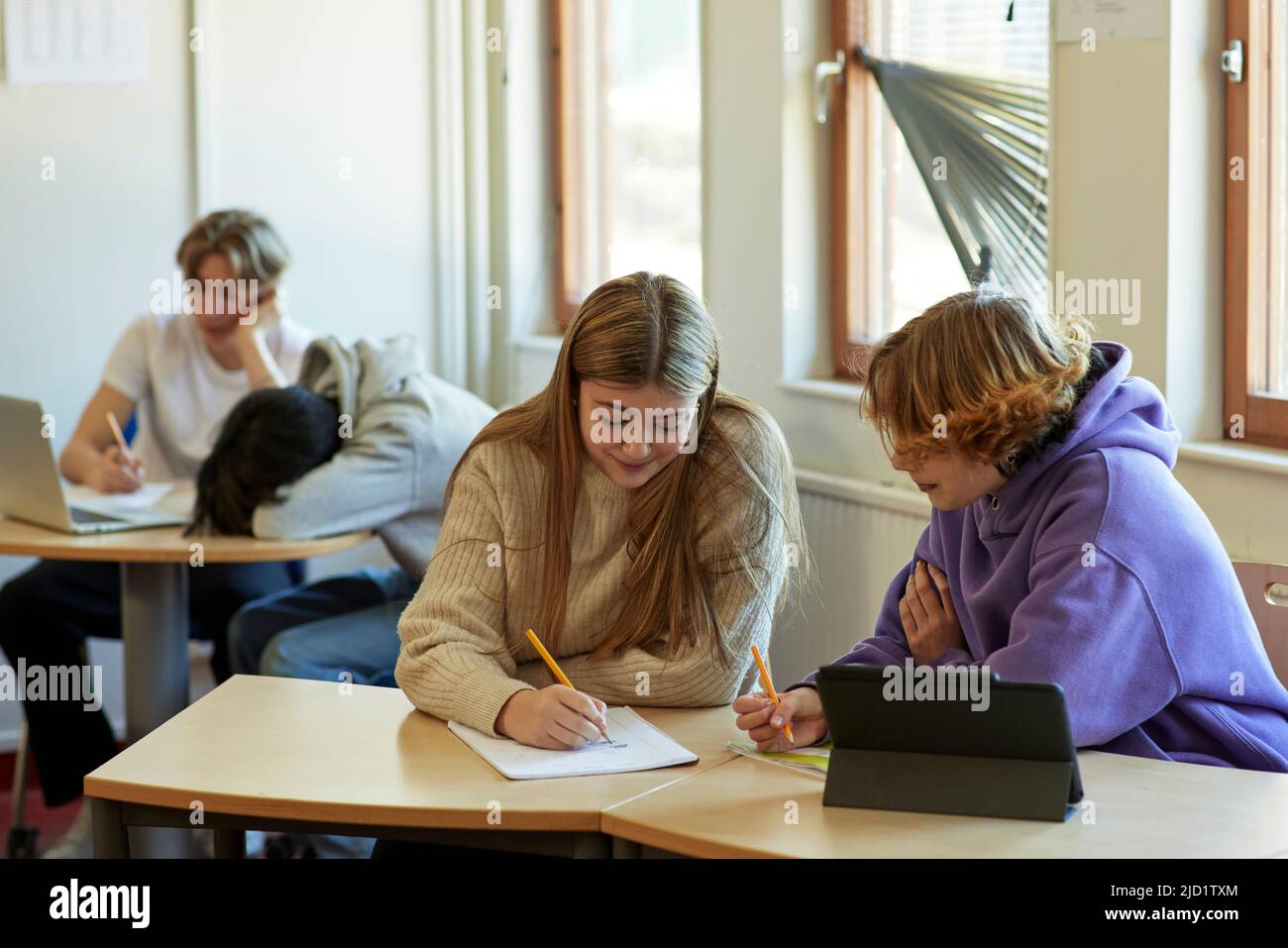 Group of students taking notes in class Stock Photo