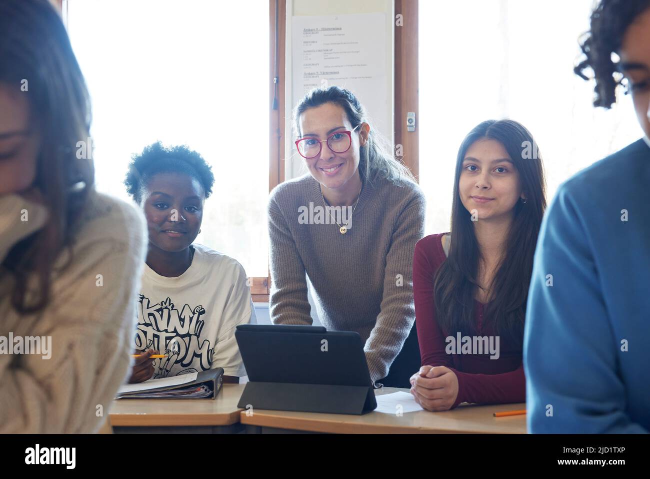 Female teacher and students in class Stock Photo