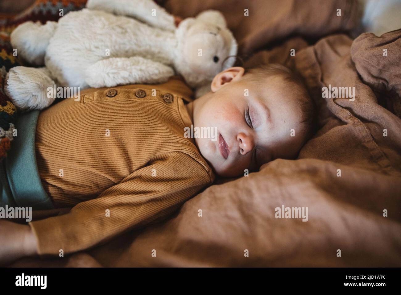 Baby sleeping on bed Stock Photo Alamy