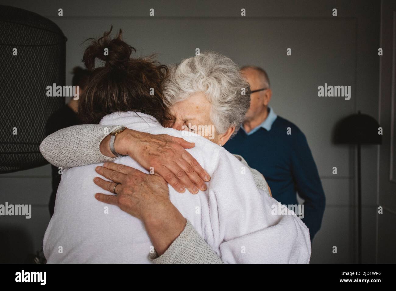 Women hugging at home Stock Photo