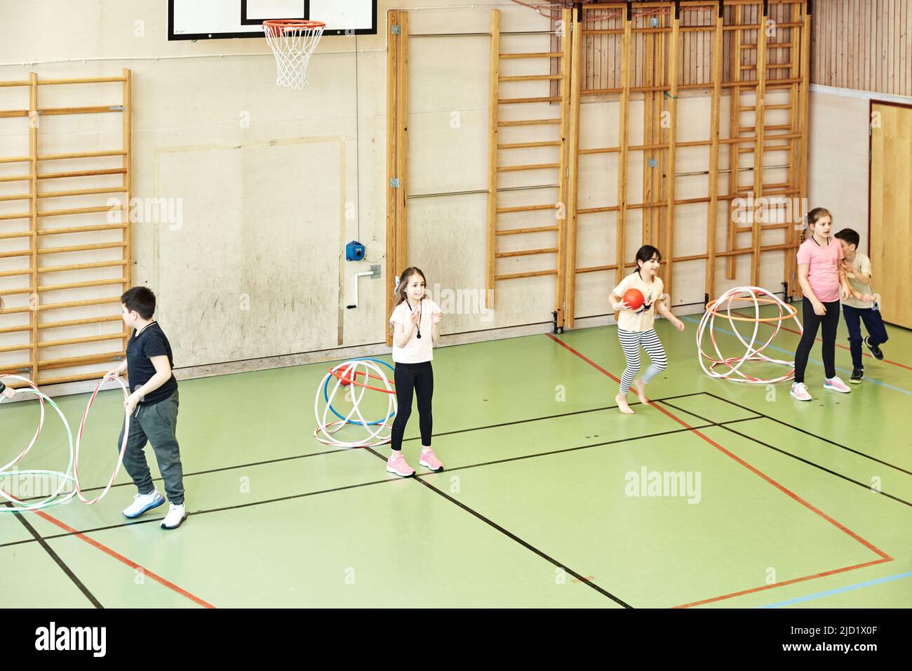 Children having PE class in school gym Stock Photo