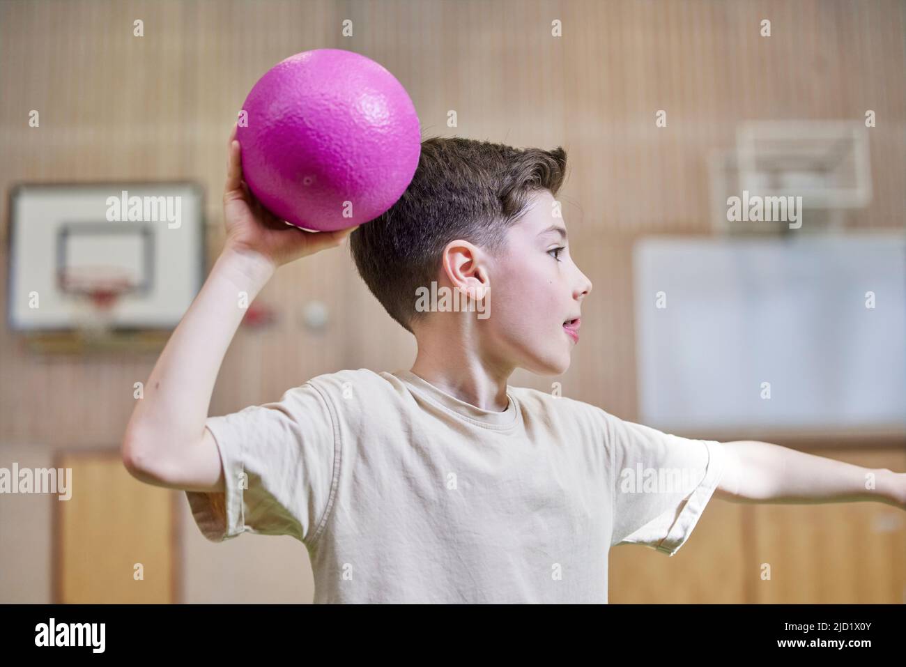 Boy throwing ball during PE class Stock Photo Alamy