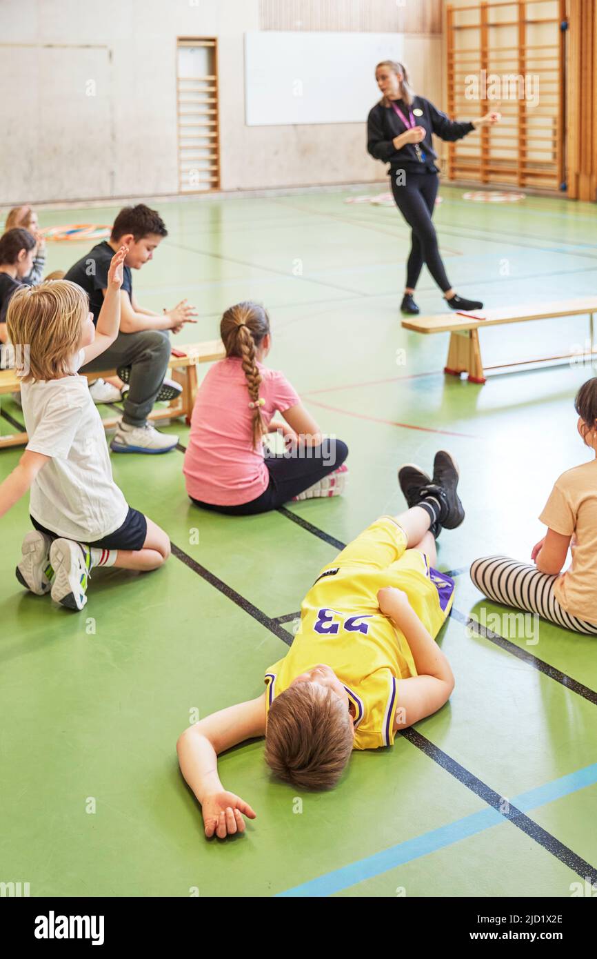 Children having class in school gym Stock Photo