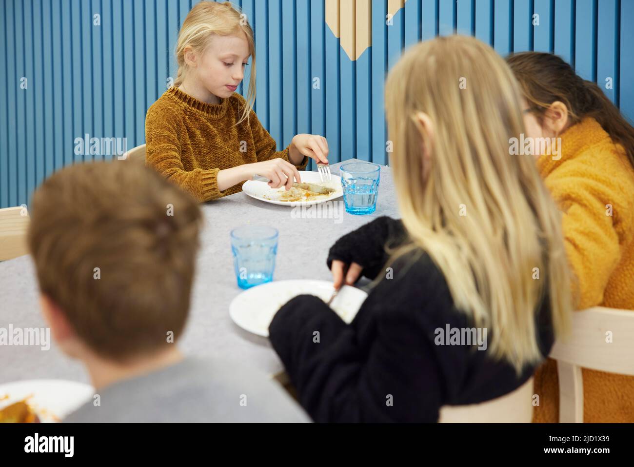 Children having lunch in cafeteria Stock Photo