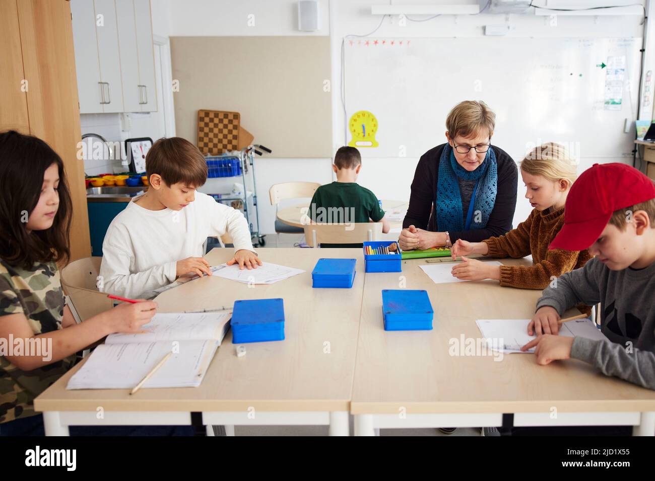 Students and teacher sitting in classroom Stock Photo - Alamy