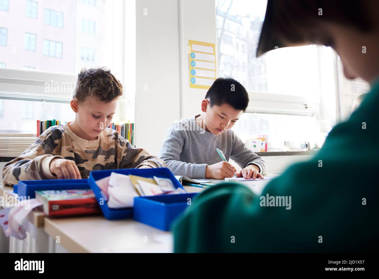 Boy students sitting in classroom Stock Photo