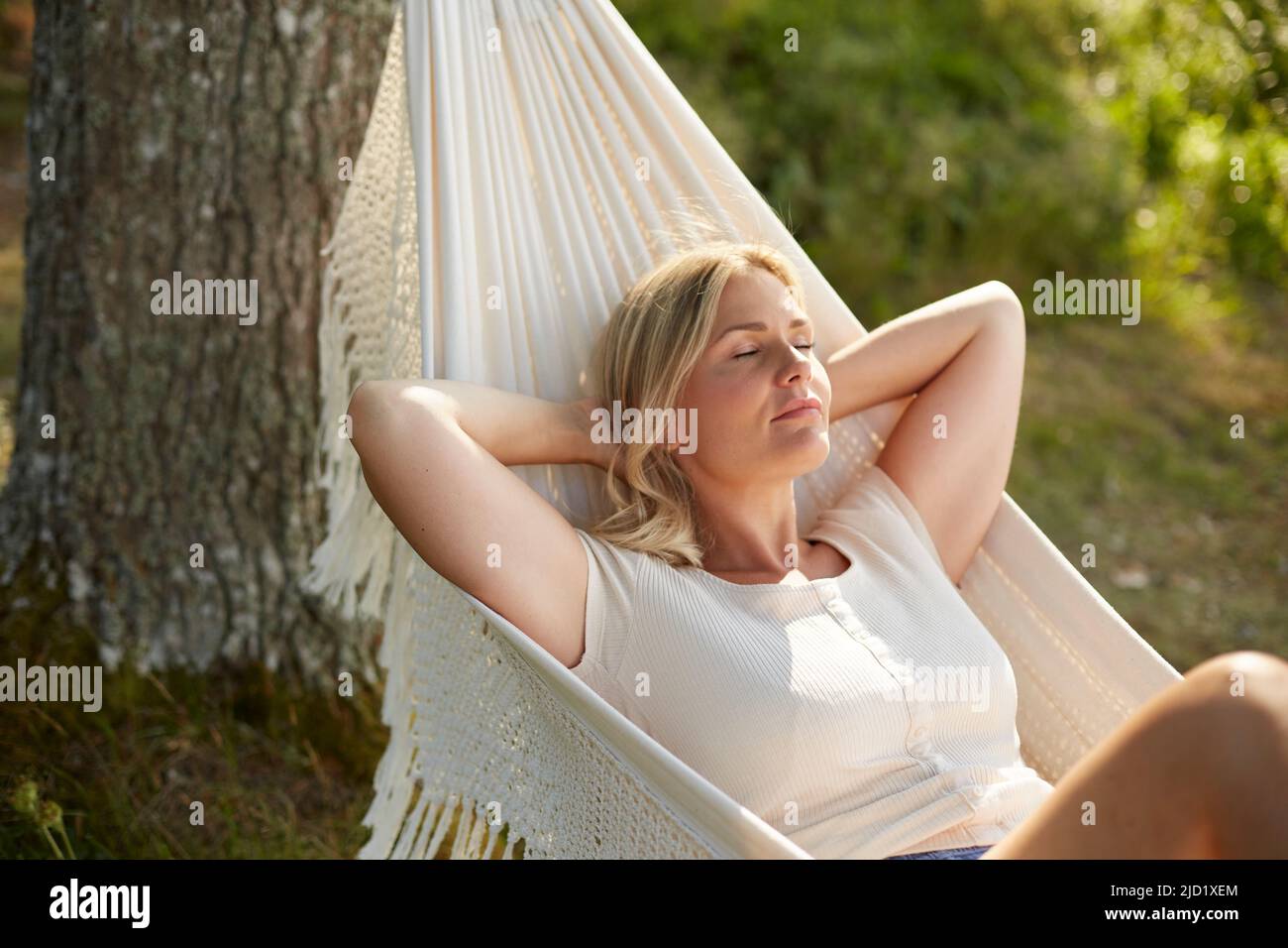 Woman relaxing on hammock Stock Photo