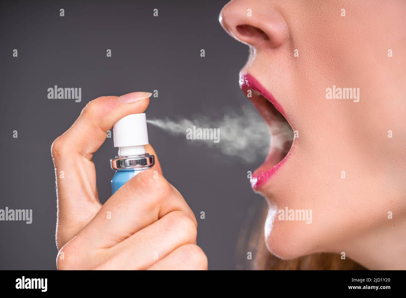 Closeup Of A Woman Applying Fresh Breath Spray Stock Photo Alamy