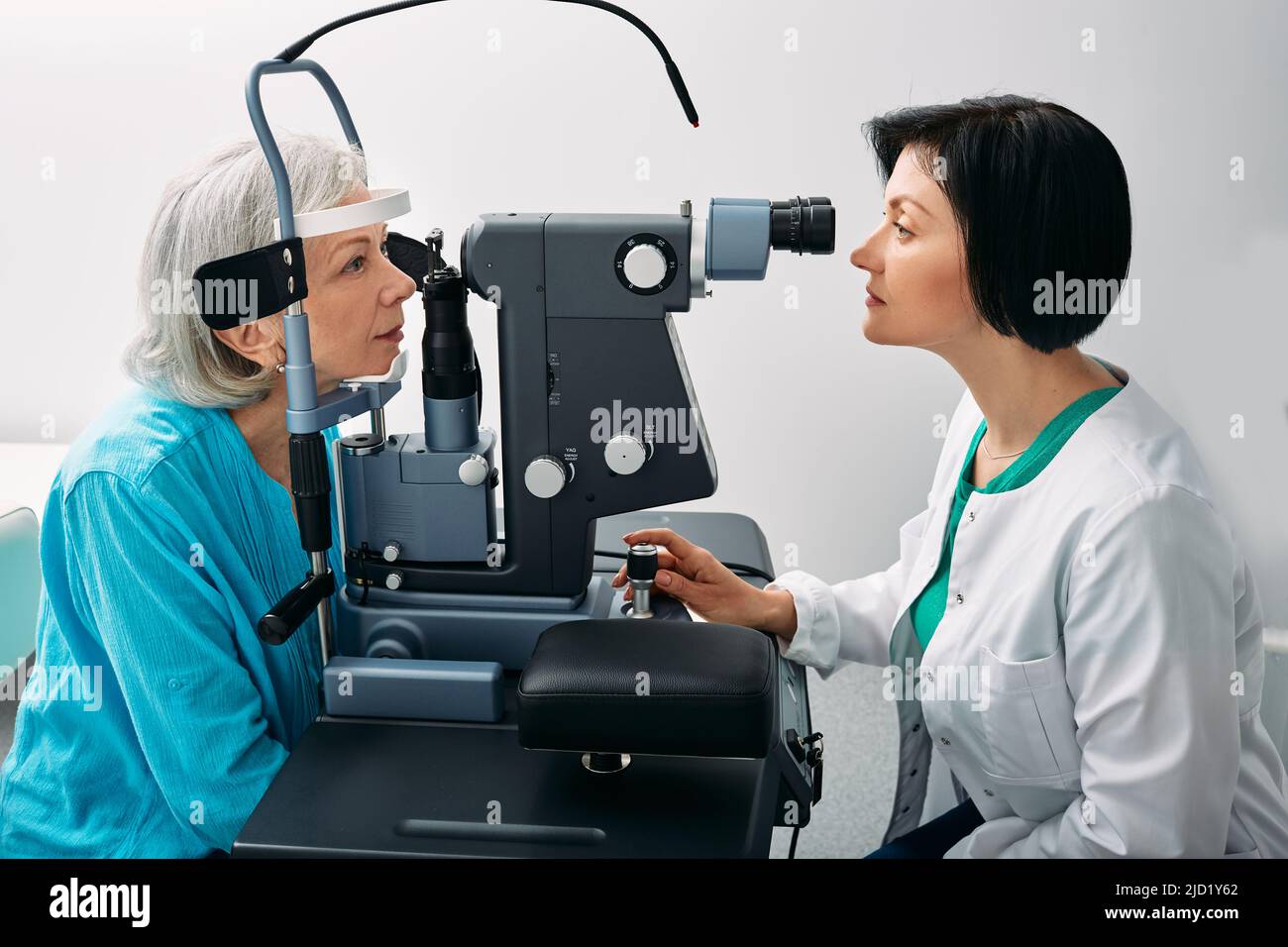 Senior woman getting eye exam at ophthalmology clinic with optometrist. Ophthalmology for older people Stock Photo