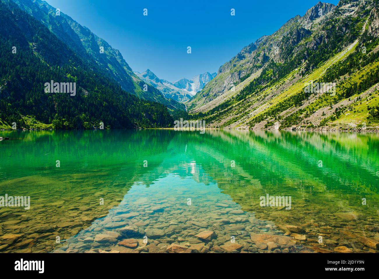 Reflections of the mountains on the calm waters of Lake Gaube in France. Zen atmosphere. Very colorful. Postcard landscape. Place for text Stock Photo