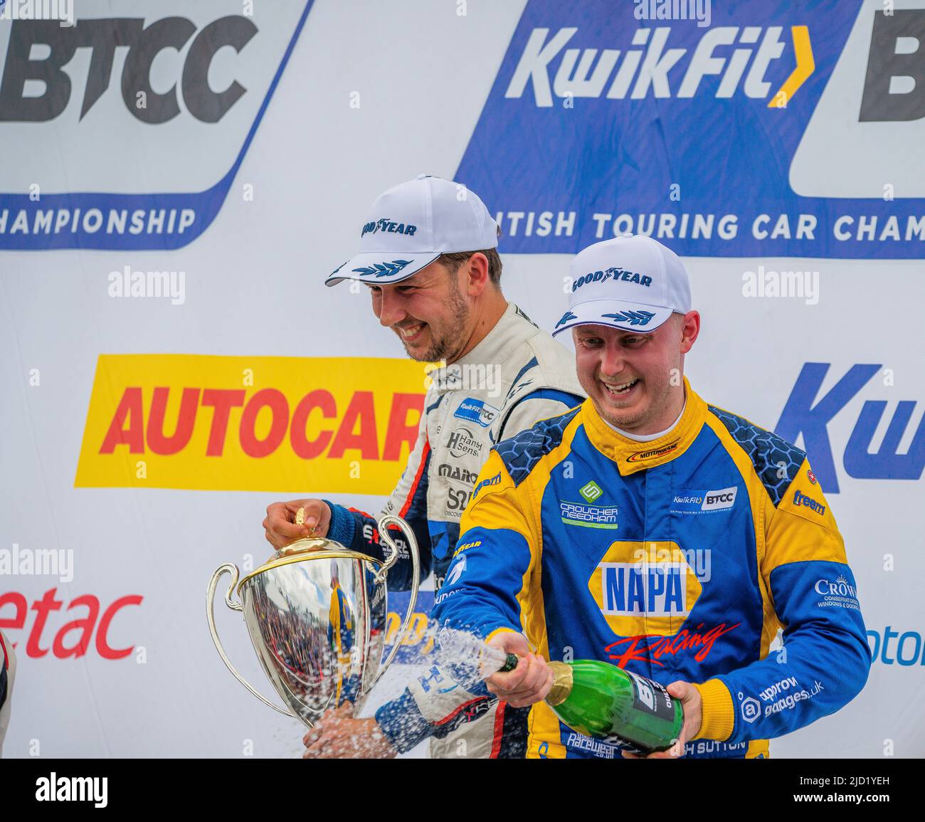 Ashley Sutton and Tom Ingram on the podium at Oulton Park, with Ash Sutton spraying champagne onto the crowd, battle of Tom and Ash Stock Photo