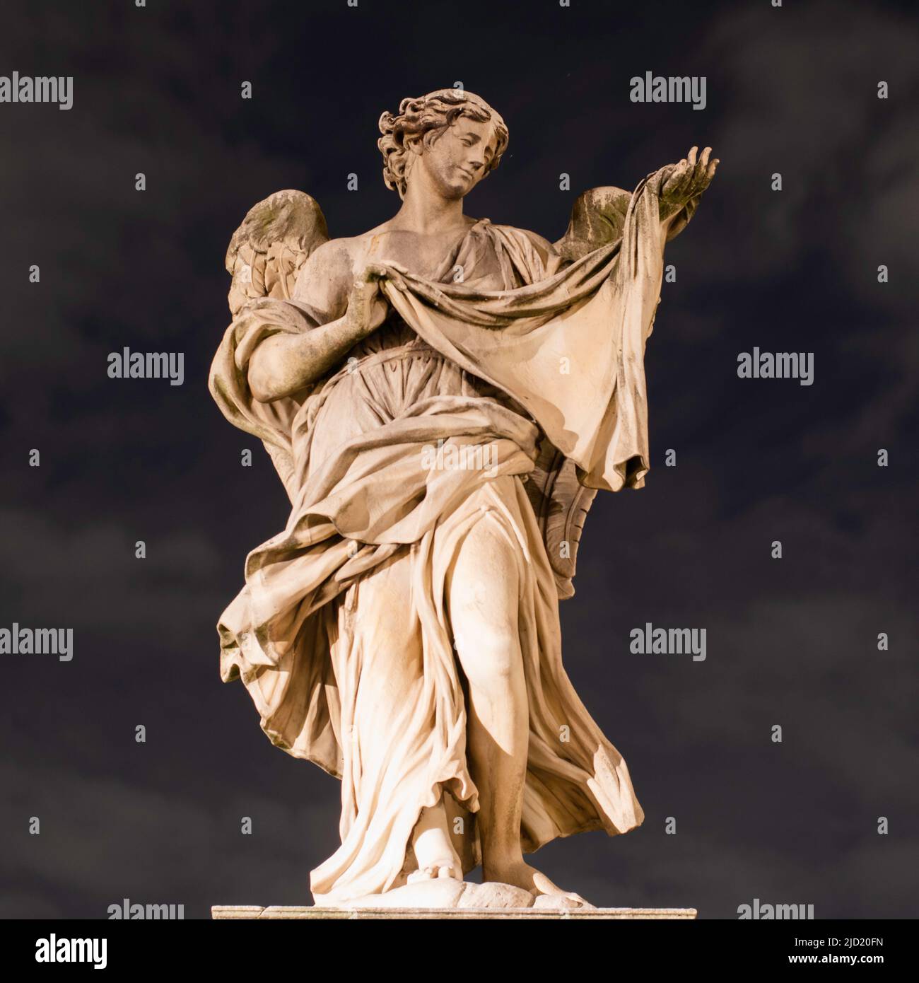 Statue On Bridge Ponte Sant'Angelo Called "Angel with the Sudarium (Veronica's Veil)" by Cosimo Fancelli At Night With Ambient Light Stock Photo