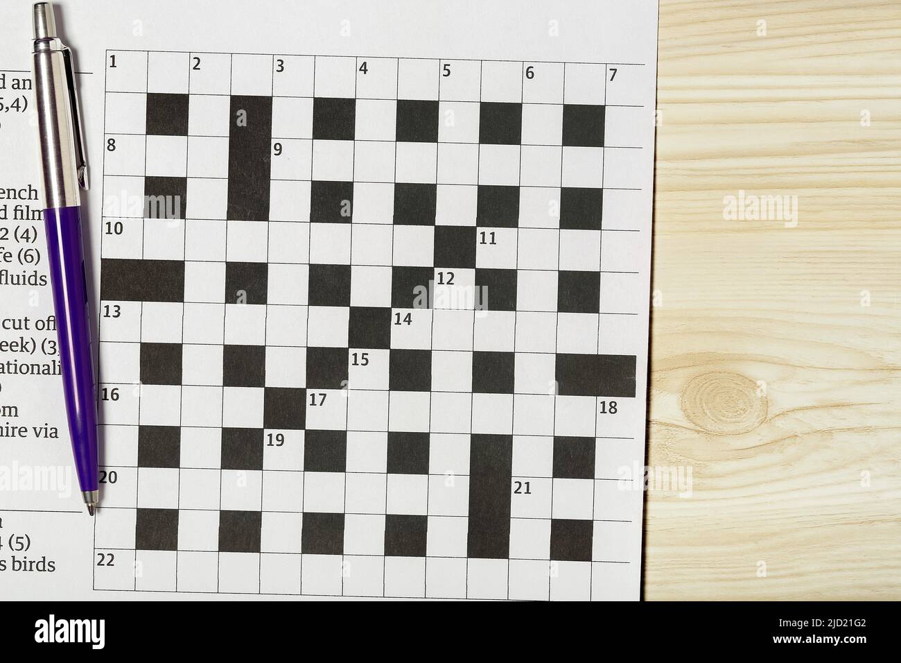 blank crossword puzzle with pen on desk Stock Photo Alamy