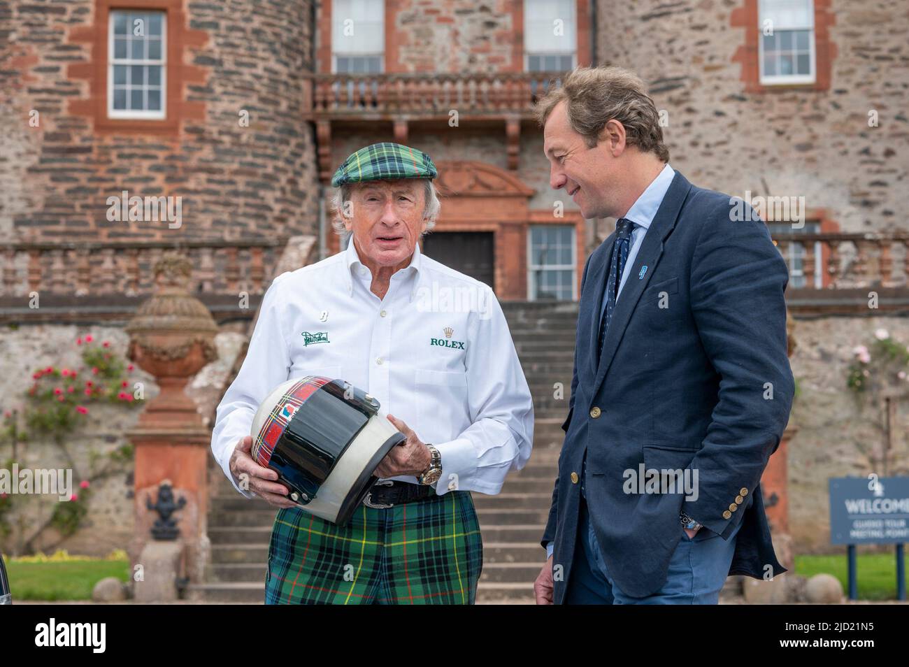 17th June 2022. Thirlestane Castle, Lauder, Scottish Borders. Sir Jackie Stewart OBE pictured with Edward Maitland-Carew.who has organised the event at his family home, Thirlestane Castle. PHOTO CAPTION Sir Jackie Stewart OBE is seen outside Thirlestane Castle in the Scottish Borders with his iconic 1969 Matra MS-80 02 which powered him to his first Formula 1 title. The Flying Scot has returned home for Scotland's biggest new motoring event, the Sir Jackie Stewart Classic - presented by Rolex, taking place this weekend (18th & 19th June). Set to be a thrilling weekend for avid motorsp Stock Photo