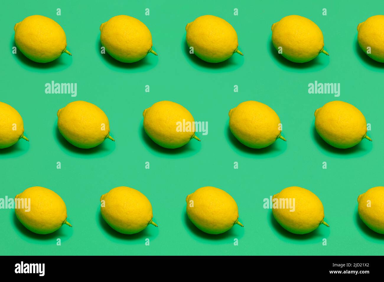 fresh lemons on green plastic surface, seamless pattern Stock Photo