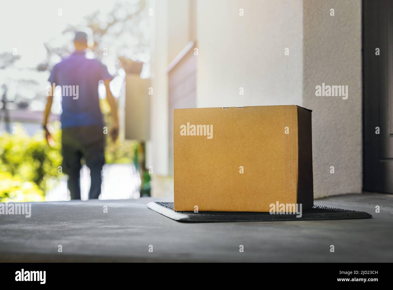 blank shipping box on the house porch. home delivery service Stock Photo