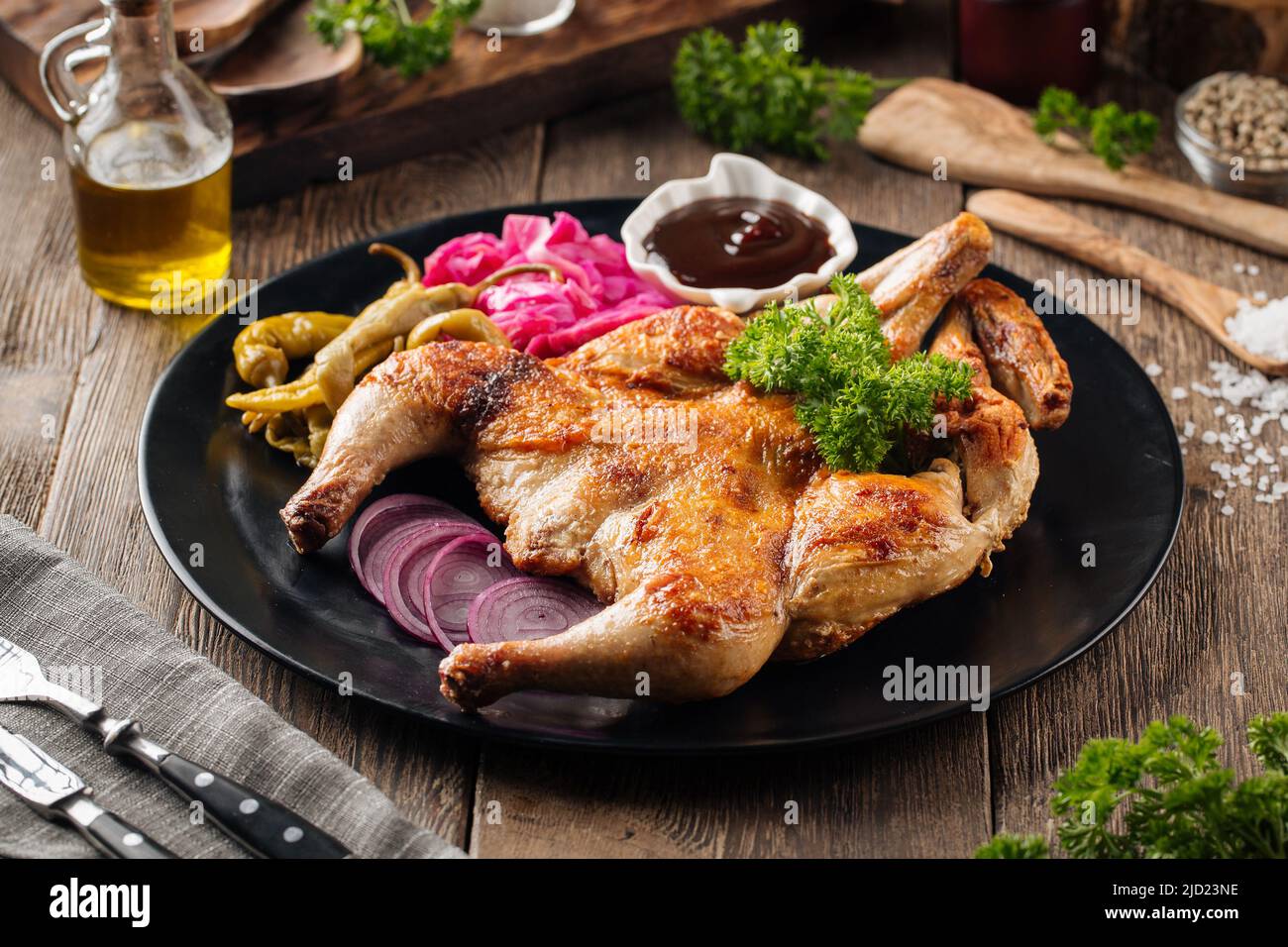 Portion of chicken tobacco dish with sauce Stock Photo - Alamy