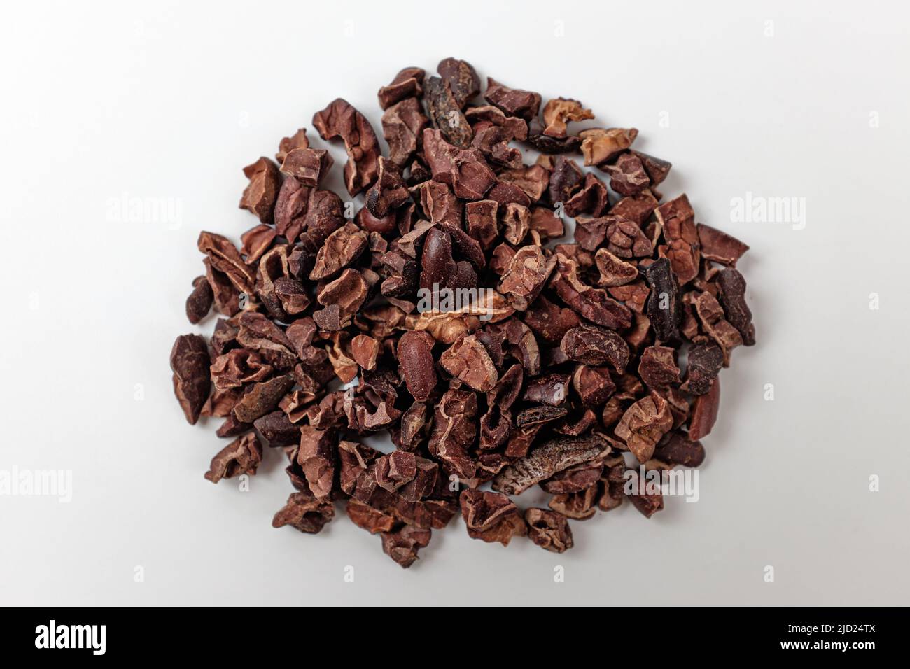 cacao nibs on a white background Stock Photo - Alamy