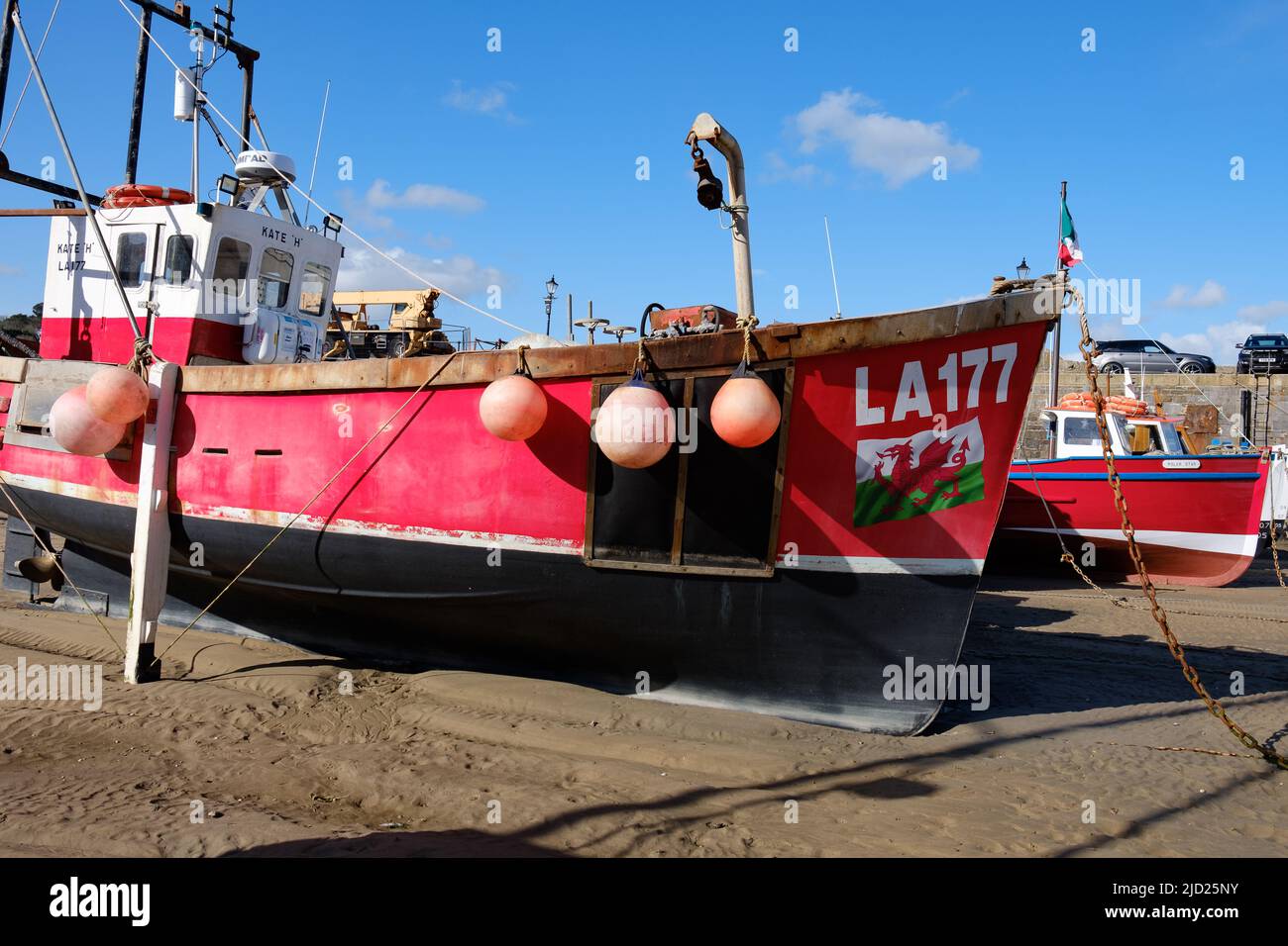 Fishing boat Kate H moored at low tide in Tenby harbour Stock Photo - Alamy