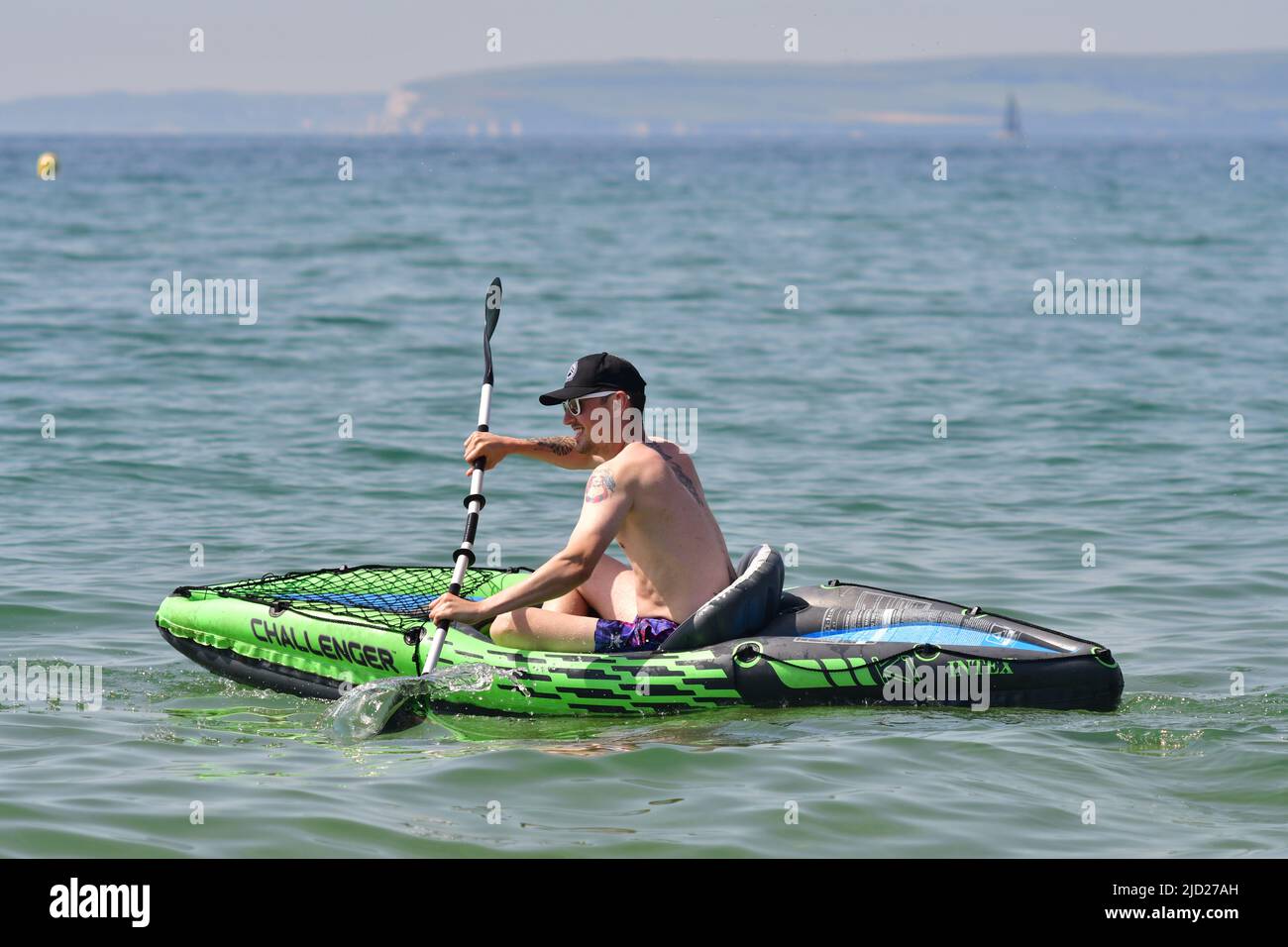 Boscombe, Bournemouth, Dorset, UK, 17th June 2022, Weather. Set to be the hottest day of the year so far as the short heatwave peaks. Man paddling out to sea in an inflatable canoe or kayak. Credit: Paul Biggins/Alamy Live News Stock Photo