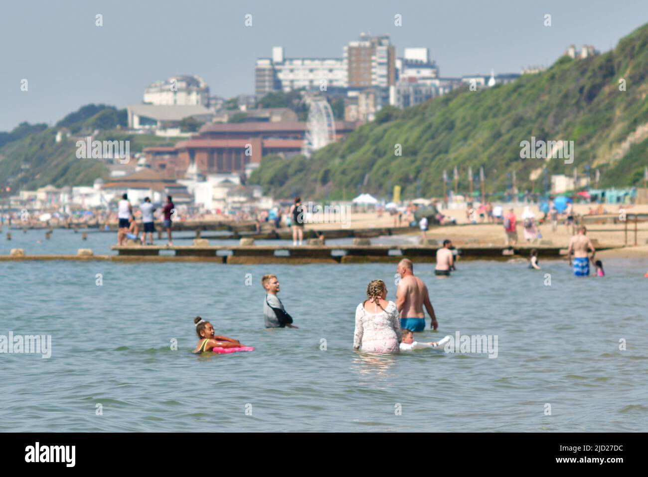 Boscombe, Bournemouth, Dorset, UK, 17th June 2022, Weather. Set to be the hottest day of the year so far as the short heatwave peaks. People head to the beach for the sunshine and swim in the sea to cool down. Credit: Paul Biggins/Alamy Live News Stock Photo