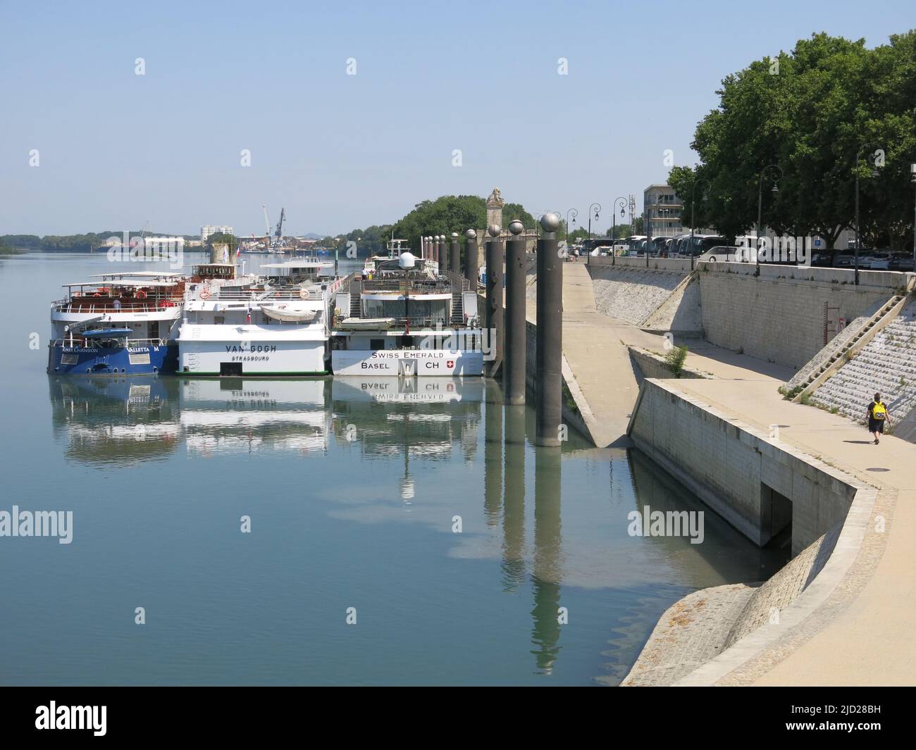 It is common practice on river cruises to moor three boats alongside each other and passengers must disembark across all three to reach the shore. Stock Photo