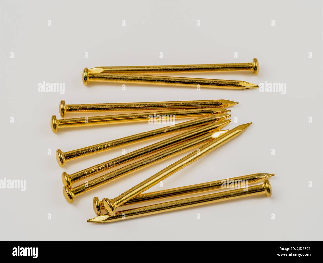 Close up of  Brass brads panel pins gold  nails Stock Photo
