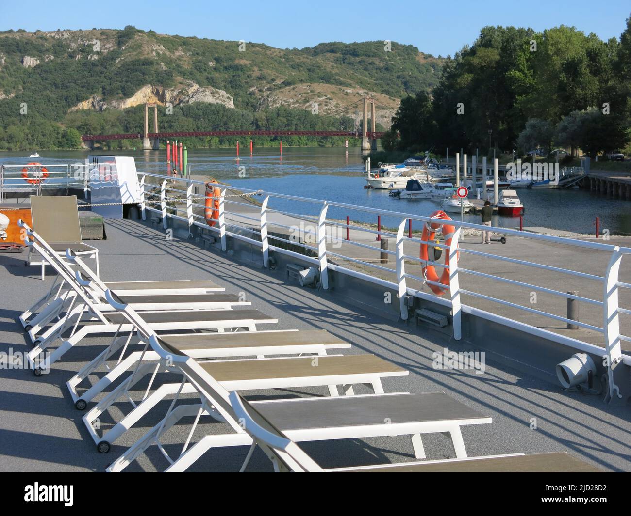 Rows of sunloungers on the top deck of the MS Van Gogh whilst moored by the marina at Viviers on the River Rhone in southern France. Stock Photo