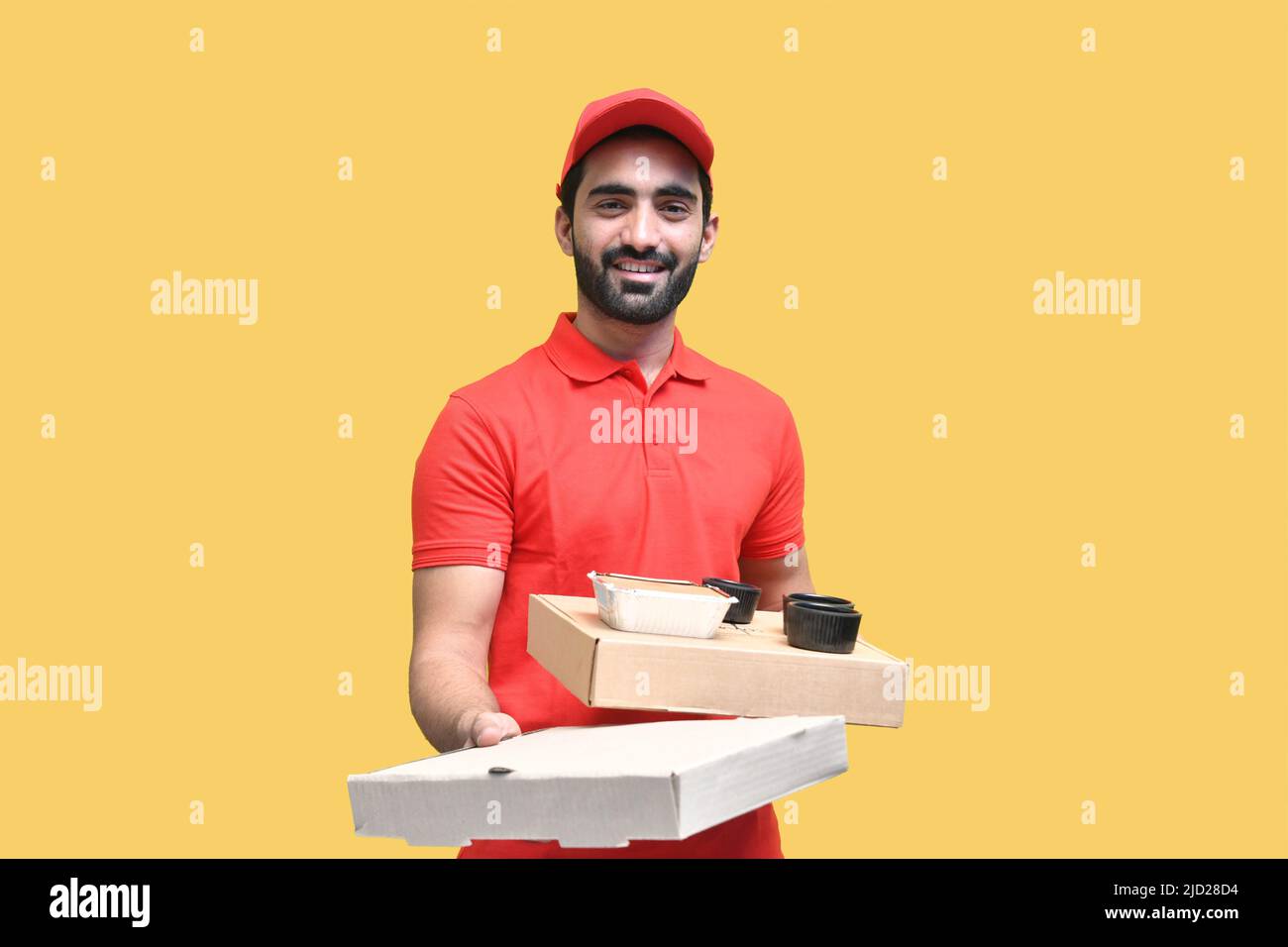 Delivery boy holding food for customers with happy face delivering on time Stock Photo