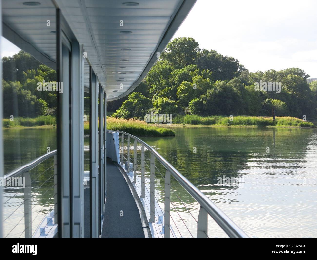 Serenity of the landscape whilst cruising on the Rhone;  river views are reflected in the panoramic windows of the MS Van Gogh's upper deck. Stock Photo