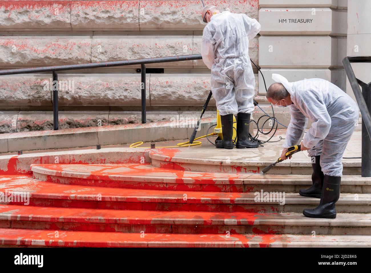 The aftermath of a red paint protest by climate change activists with 'Just Stop Oil' who sprayed the exterior wall and steps of the Treasury in Horse Guards, on 13th June 2022, in London, England. 'Just Stop Oil' took direct action for a UK government policy encouraging oil & gas expansion, they say. Stock Photo