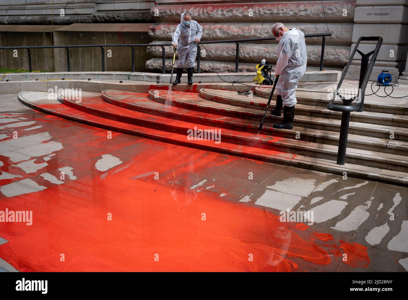 The aftermath of a red paint protest by climate change activists with 'Just Stop Oil' who sprayed the exterior wall and steps of the Treasury in Horse Guards, on 13th June 2022, in London, England. 'Just Stop Oil' took direct action for a UK government policy encouraging oil & gas expansion, they say. Stock Photo