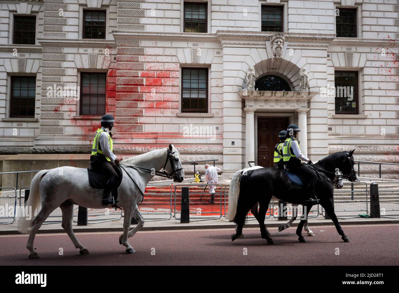 The aftermath of a red paint protest by climate change activists with 'Just Stop Oil' who sprayed the exterior and steps of the Treasury in Horseguards, on 13th June 2022, in London, England. 'Just Stop Oil' took direct action for a UK government policy encouraging oil & gas expansion, they say. Stock Photo