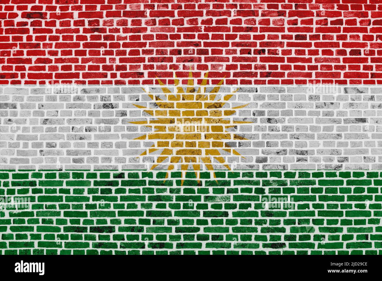 Close-up on a brick wall with the flag of Kurdistan painted on it. Stock Photo