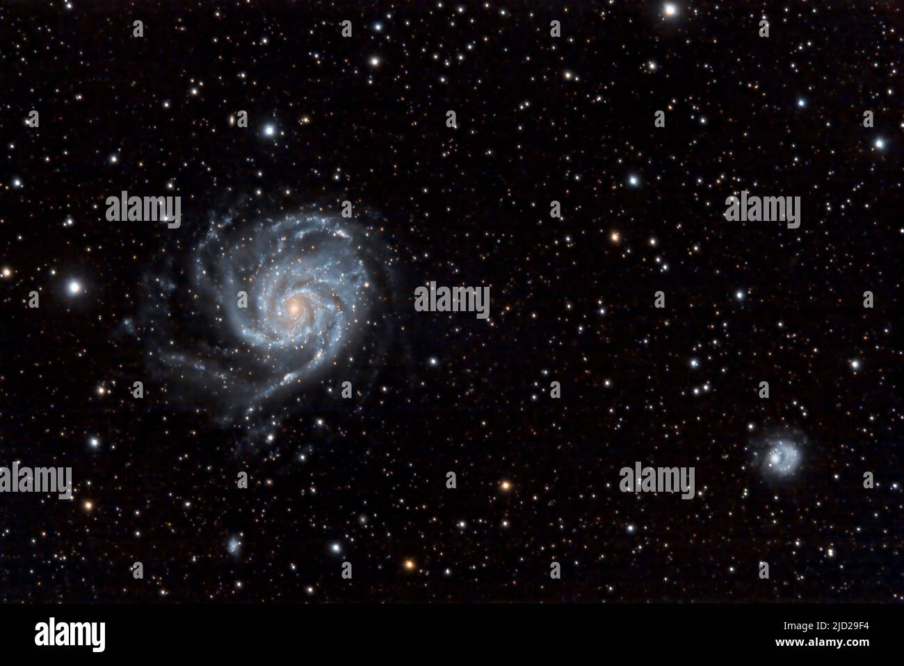 The Pinwheel Galaxy Messier 101 (NGC 5457) in the constellation Ursa Major (Big Dipper).  At lower right are the galaxies NGC5174 and PGC4545422. Stock Photo
