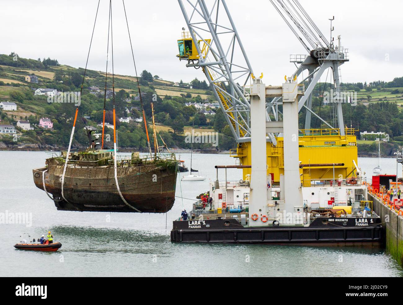 Shipwreck being lifted onto Lara 1 floating crane ship deck keelbeg pier Union Hall, West Cork, Ireland Stock Photo