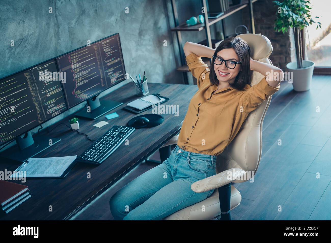 Portrait of attractive cheerful experienced girl company director developing web site project at workplace workstation indoors Stock Photo