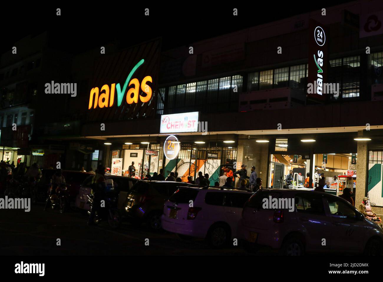 Cars are seen parked at the front side of a branch of Naivas